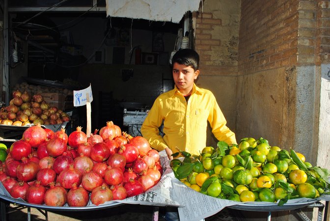 Iranian boy selling fruit in the city of Kashan.